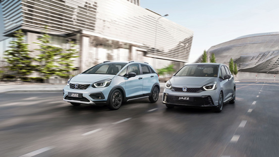 Honda Jazz Crosstar and Honda Jazz Advance Sport driving side by side in a sunny urban setting.